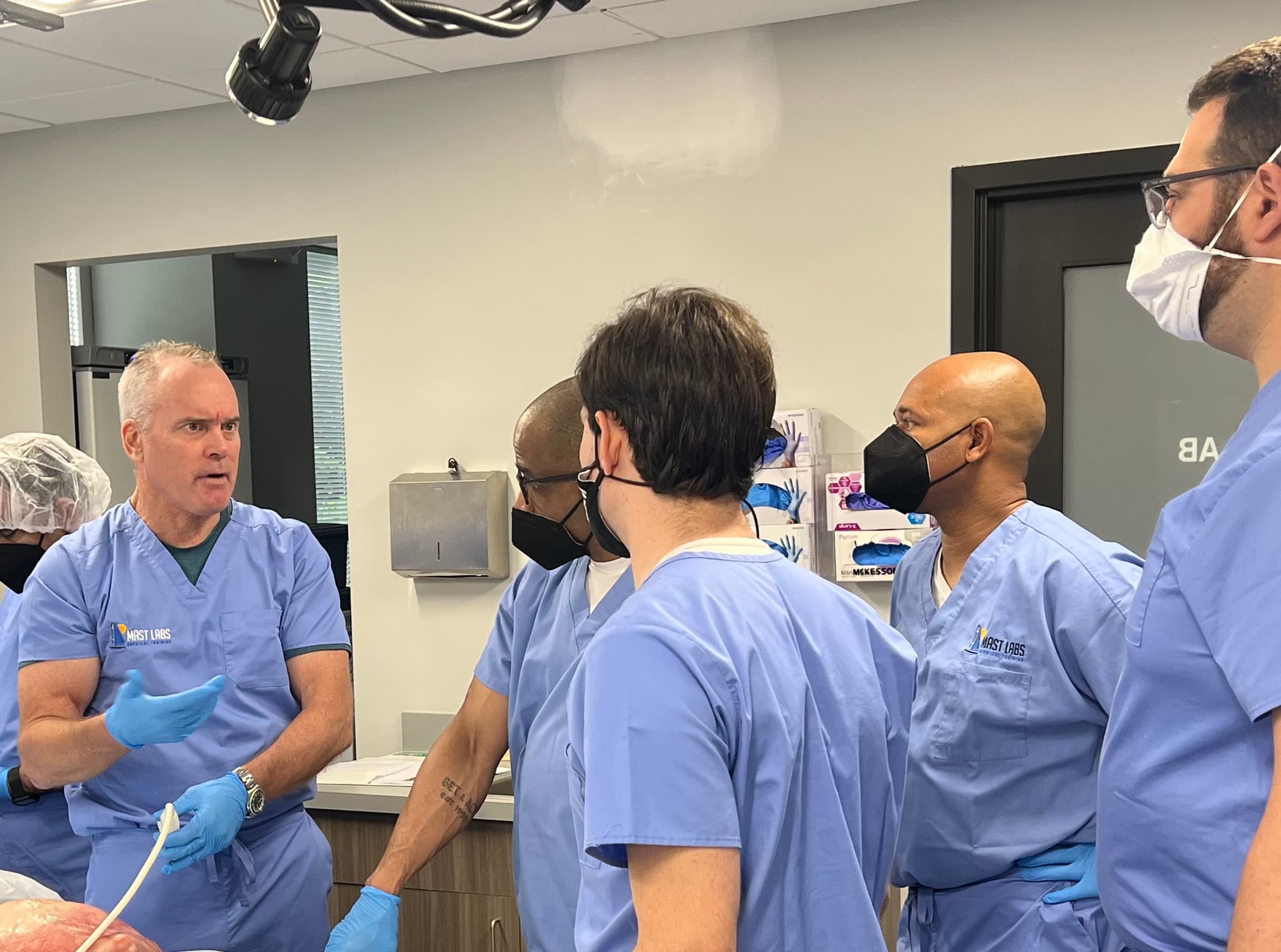 Dr. Mulvaney teaching regenerative injection technique to physicians in a surgical training lab