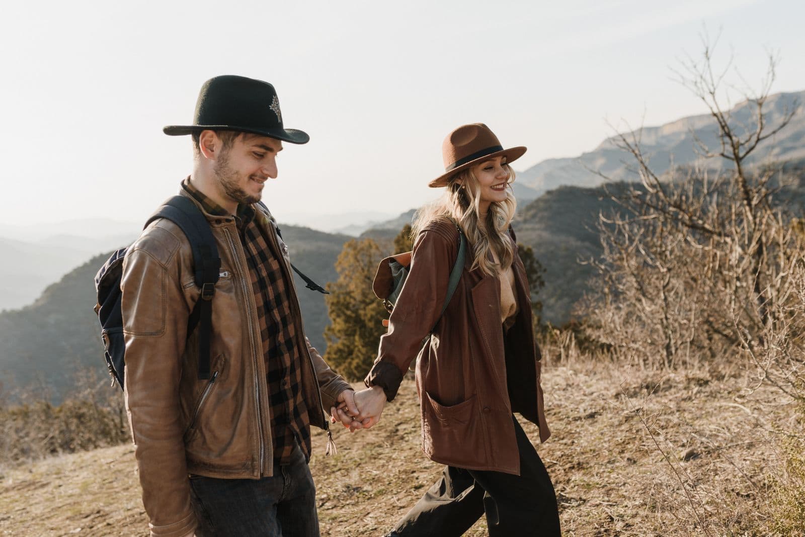 A happy couple hiking together on a scenic mountain trail